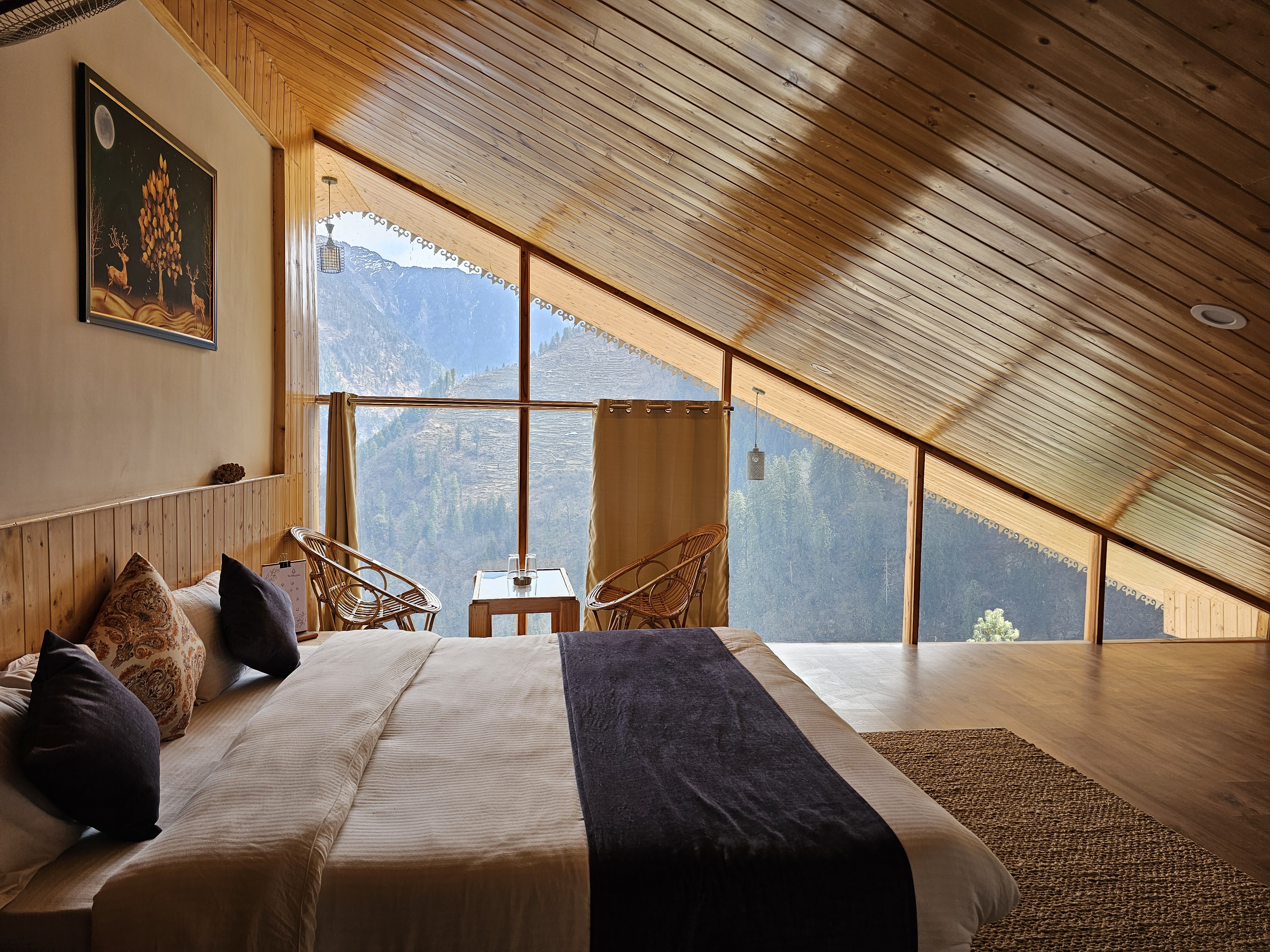 Executive Room under a gabled pine ceiling with a panoramic mountain window